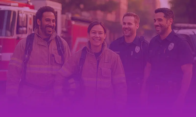 Firefighters and police officers smiling together while representing first responder mental health support