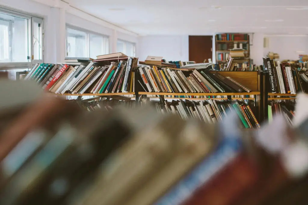 Books on library shelves representing learning, community resources, and mental well-being