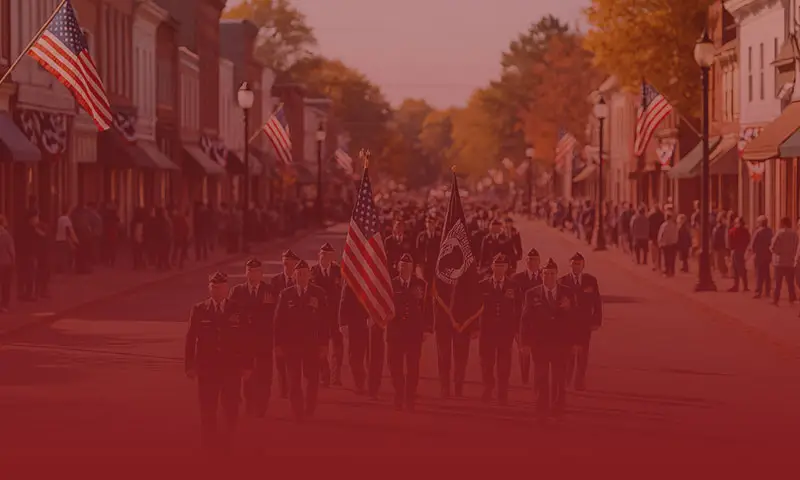 Veterans marching in a community parade with American flags to represent veteran support and connection